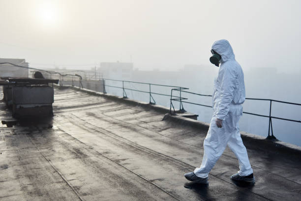 istock Worker scientist wearing protective coverall and gas mask doing ecological tests on the roof 1204628526