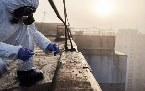 istock Worker scientist wearing protective coverall and gas mask doing ecological tests on the roof 1204628535