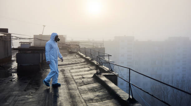 istock Worker scientist wearing protective coverall and gas mask doing ecological tests on the roof 1204628536