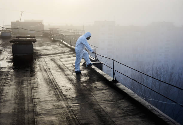 istock Worker scientist wearing protective coverall and gas mask doing ecological tests on the roof 1204628556