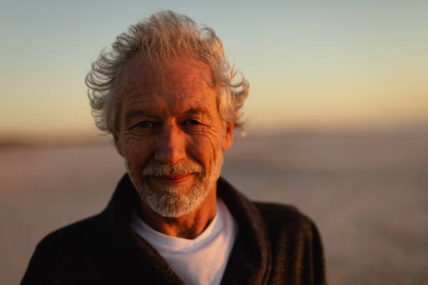 istock Old man relaxing at the beach 1204629692