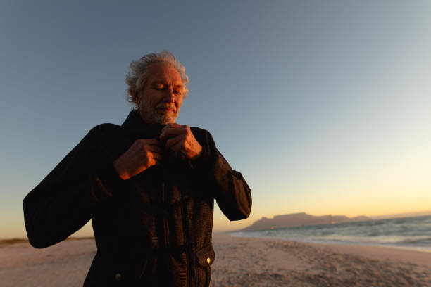 istock Old man relaxing at the beach 1204629705