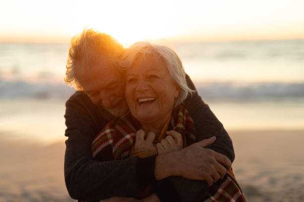 istock Old couple in love at the beach 1204629719