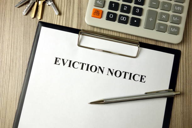 istock Home eviction notice legal document with pen calculator and keys 1204629842
