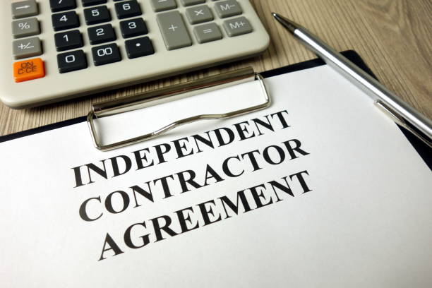 istock Independent Contractor Agreement with calculator and pen 1204630986