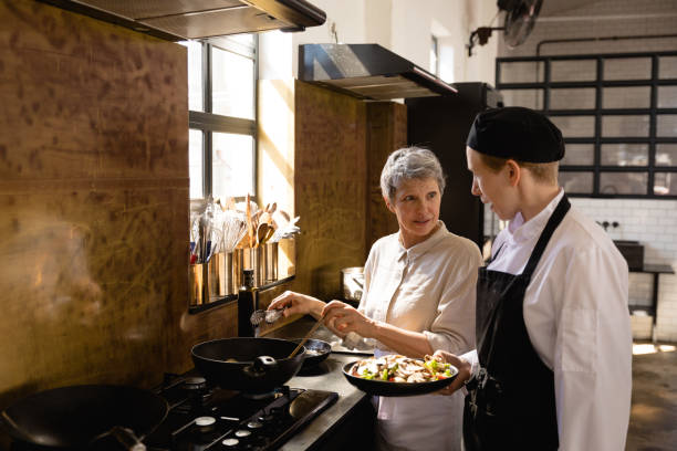istock Caucasian chefs cooking vegetables 1204631464