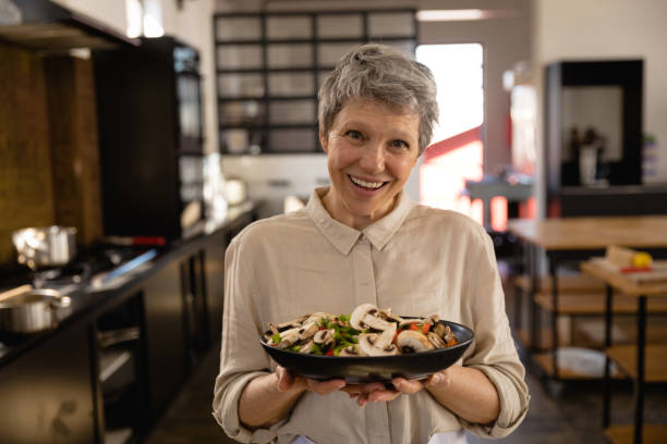 istock Caucasian chef showing her dish 1204631547
