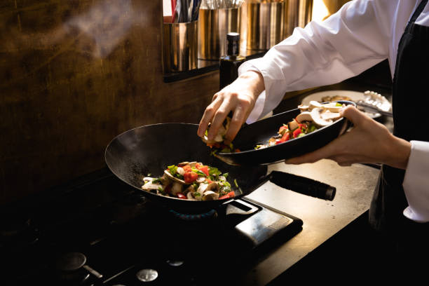 istock Caucasian chef cooking vegetables 1204631580