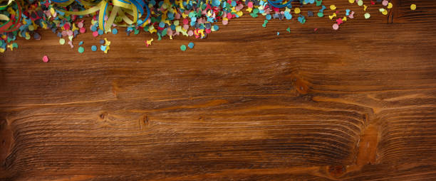 istock Colorful confetti on wooden texture 1204632920