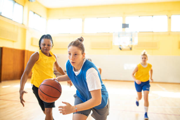 istock Female basketball player running in offence during friendly match 1204633107