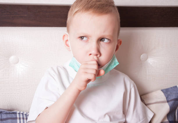 istock Ill boy suffering from cough in bed at home 1204633131