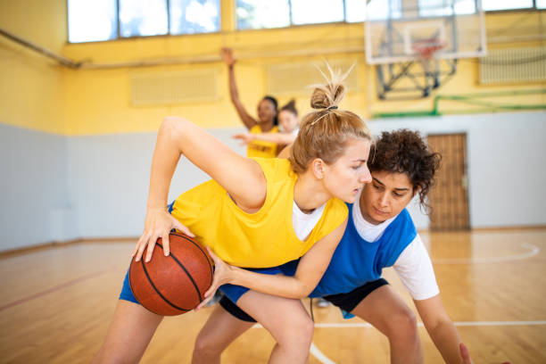 istock Young female basketball player trying to make a play during training 1204633190