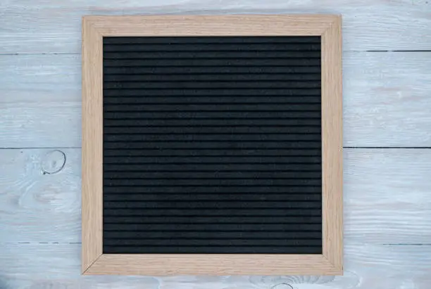 empty black felt letterboard on natural wood background. procurement for design