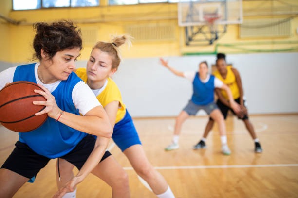 istock Young female basketball player trying to make a play during training 1204633944