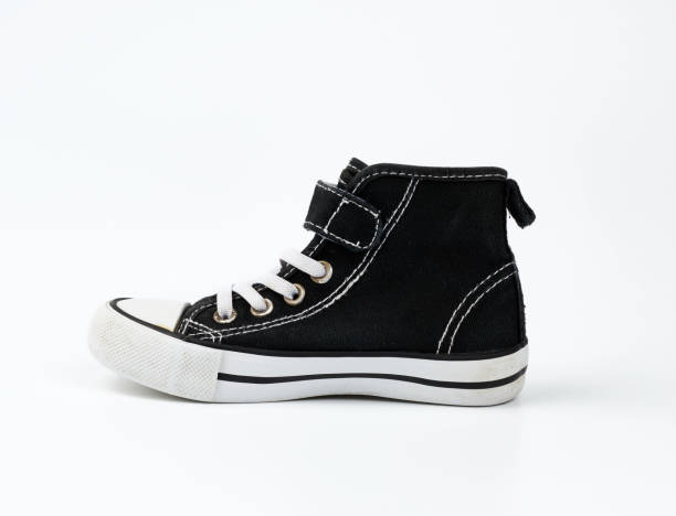 istock black textile sneaker with white tied shoelaces on a white background 1204634333