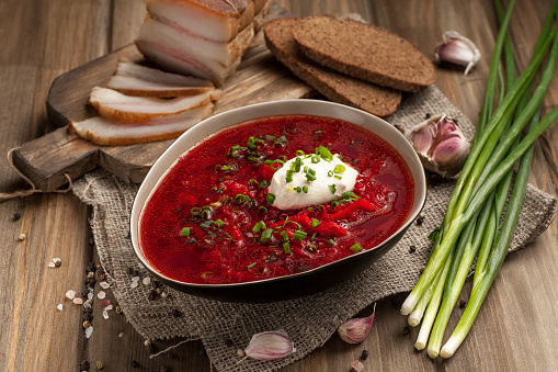 Borscht. Traditional hot dish of Russian and Ukrainian cuisine. Hot soup served in a deep plate. Close up and horizontal orientation. \