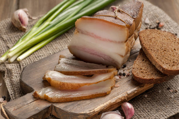 Lard and bread. Traditional Russian fatty snack with green onions and garlic. stock photo