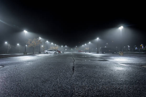 istock Wet Parking Lot on a Misty Night 1204637715