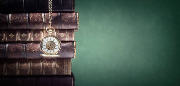 istock Pocket watch and books background in library or study 1204637720