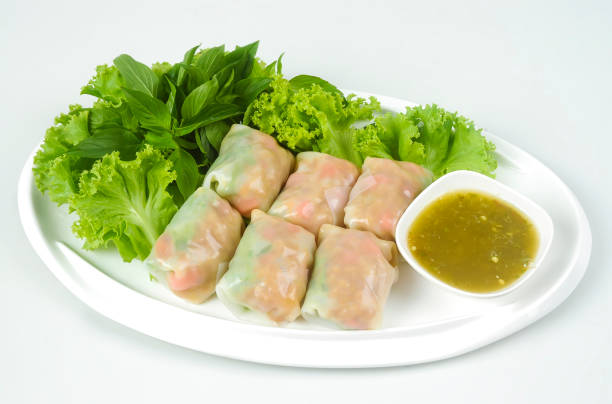 istock Vietnamese spring roll. Spring rolls with vegetables and rice paper. Fresh Vietnamese spring rolls on a plate with salad. Vietnamese Food. 1204637730