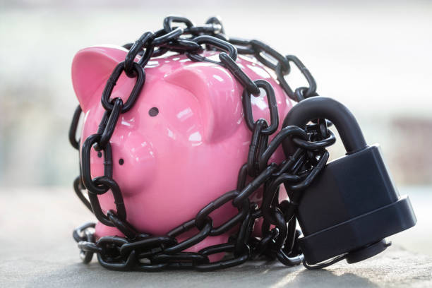 piggy bank secured with padlock chained up and locked - chain guard imagens e fotografias de stock