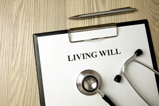 Living will directive with stethoscope and pen, medical or legal concept
