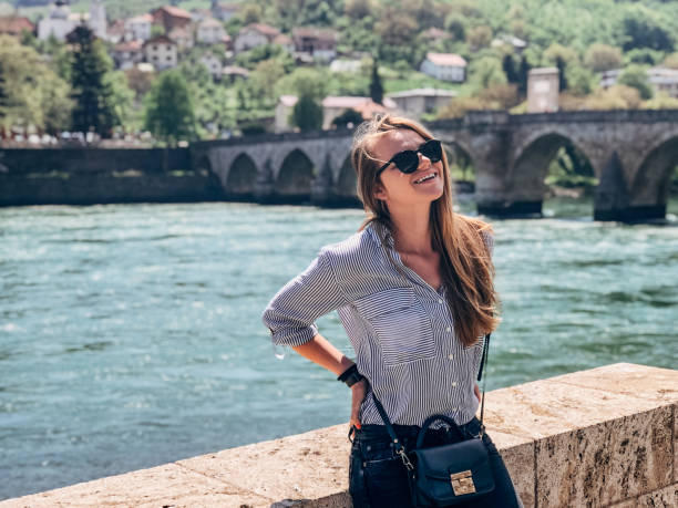 istock One woman sitting by the bridge on Drina river 1204638510