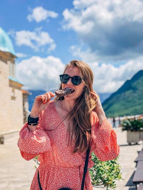 istock One woman on vacation eating ice cream 1204639706