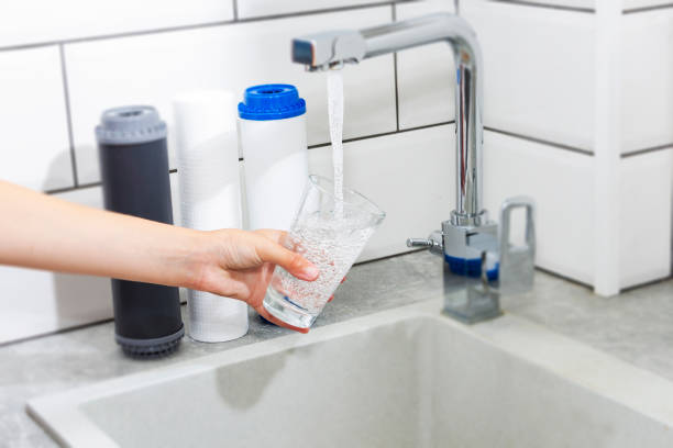 istock The tap from which water flows. Quenching thirst. Water problems in some countries.The glass is filled with water. 1204640730