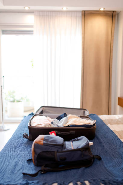 istock Onboard travel bag half packed for a summer break 1204640898