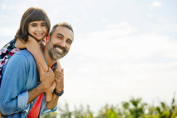 istock Smiling father giving piggyback ride to daughter 1204641111
