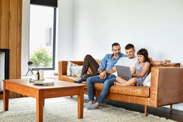 istock Bisexual men sitting with girl using laptop 1204641153