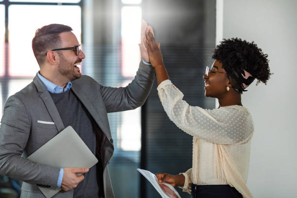 Two excited business colleagues team give high five