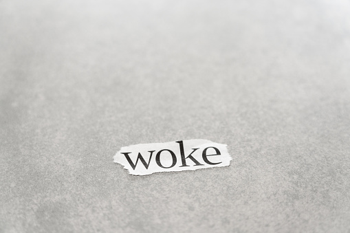 The word 'woke', torn from a newspaper headline.