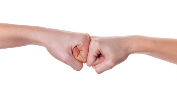 istock Hands giving a fist bump on white background 1204643666