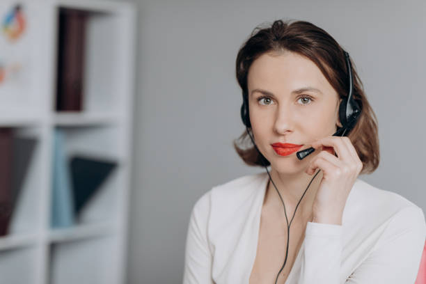 istock Beautiful Women Call Center Wear Headset and Working with Computer while Consulting Customer with Online Problem. Support and Operator Service Business Representative Concept. Online marketing 1204643751