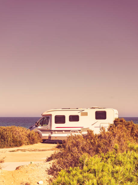 istock Camper car on beach, camping on seashore 1204644039