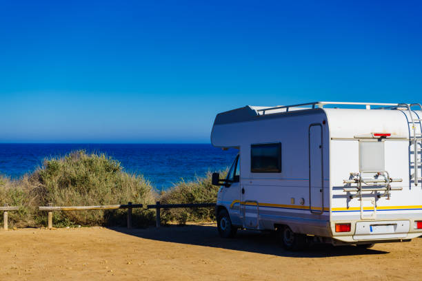 istock Camper car on beach, camping on seashore 1204645072