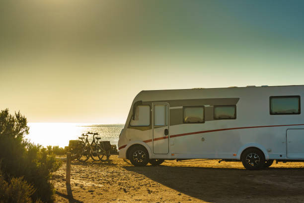 istock Camper car on beach, camping on seashore 1204645125