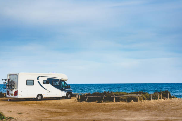 istock Camper car on beach, camping on nature 1204645174