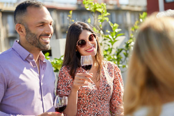 istock Couple enjoying drinks with family on terrace 1204646437