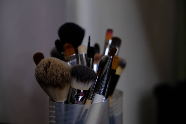 istock Set of a cosmetic brushes. Makeup brushes on dark background 1204647128