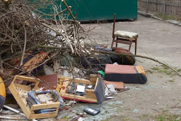 A pile of household furnishings, damaged by Hurricane, placed curbside, awaiting trash removal.