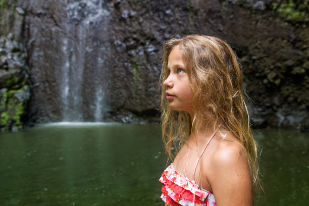 Young girl at the waterfall in Madeira Island