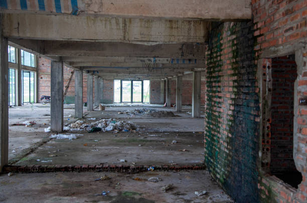 istock Abandoned Empty Room, ruined building, room with broken windows, Room with two windows in abandoned ruined house. Abandoned building inside interior 1204650535