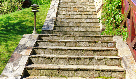 Stone made stairs in the backyard garden