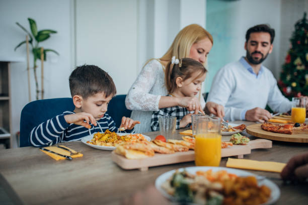 istock Children having lunch with parents together at home 1204651285