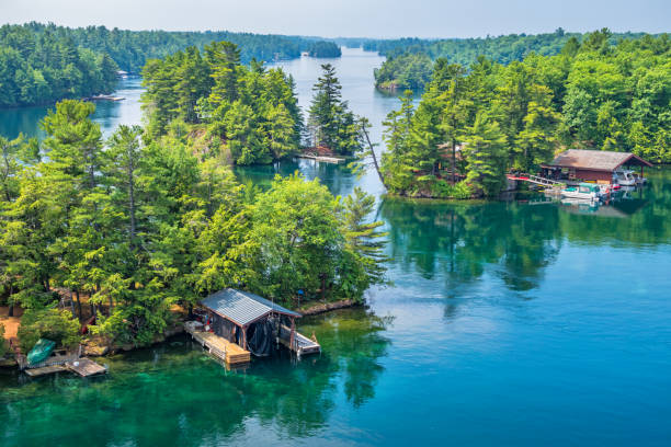 Thousand Islands National Park Canada and USA 1000 Islands Stock photograph of islands and boathouses in Thousand Islands National Park located on the St Lawrence River between Canada and the USA. thousand islands canada stock pictures, royalty-free photos & images