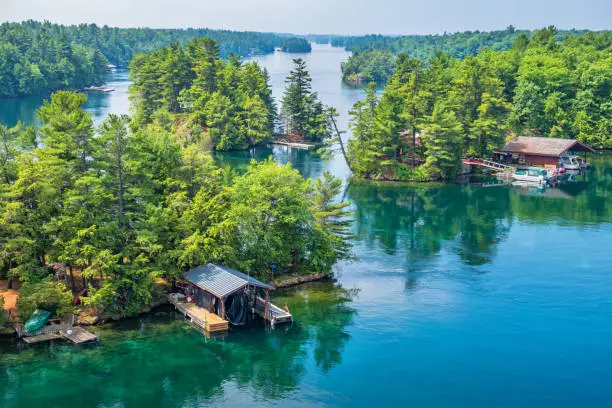 Stock photograph of islands and boathouses in Thousand Islands National Park located on the St Lawrence River between Canada and the USA.