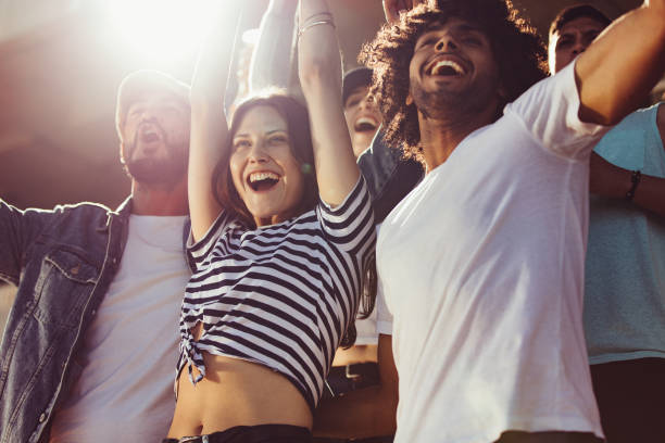 istock Group of soccer fans cheering for their team 1204651992